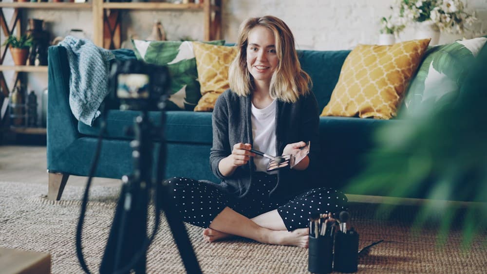 Creator holding a camera while seated